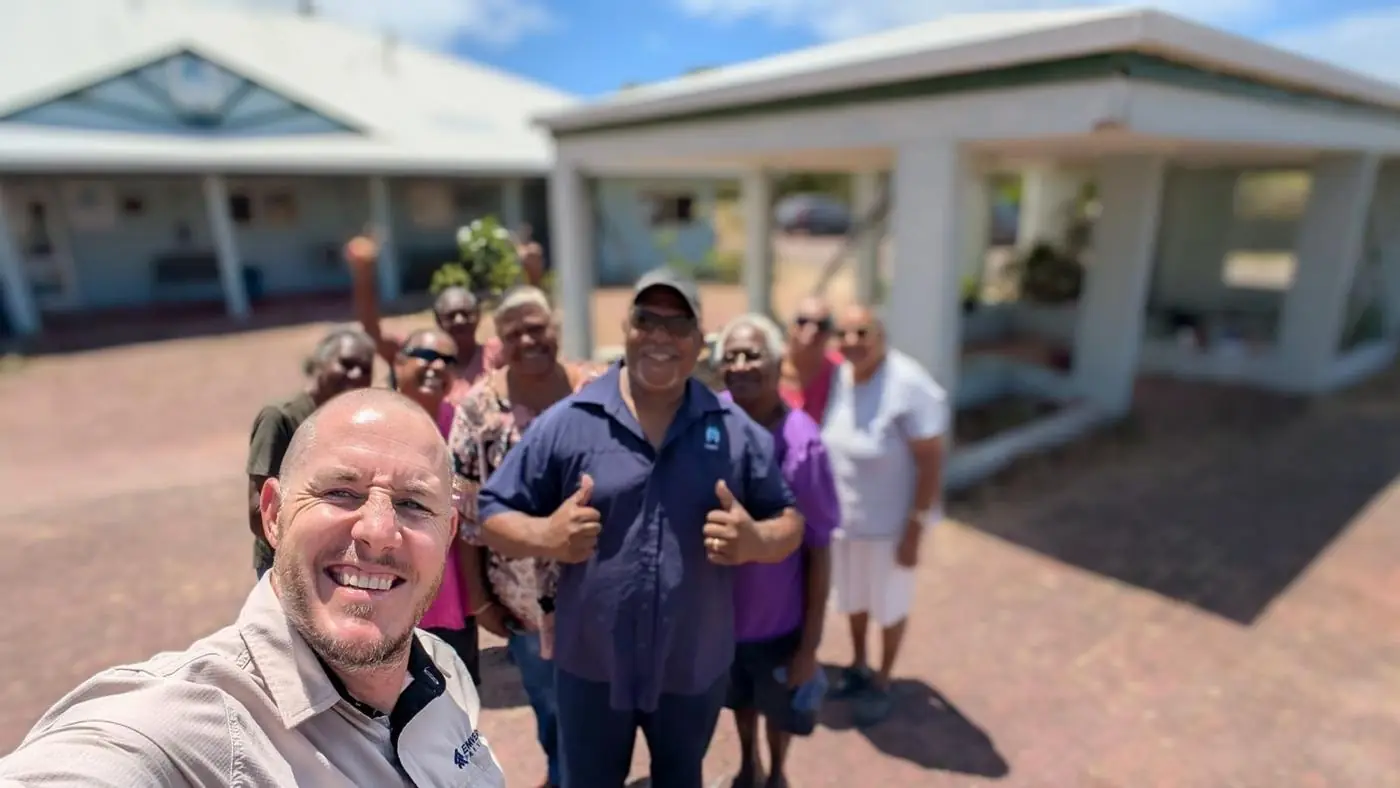 John Palmer with community members outside a building at St Pauls