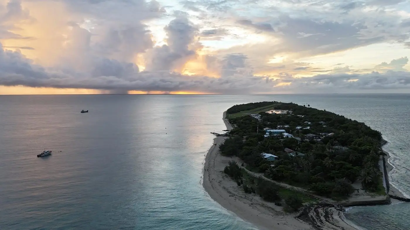 A small island at dusk with calm water