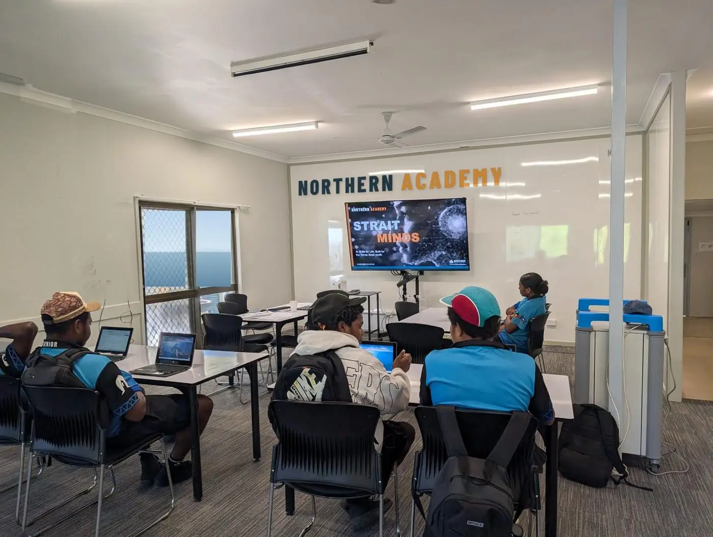 Students in a classroom with a Northern Academy banner